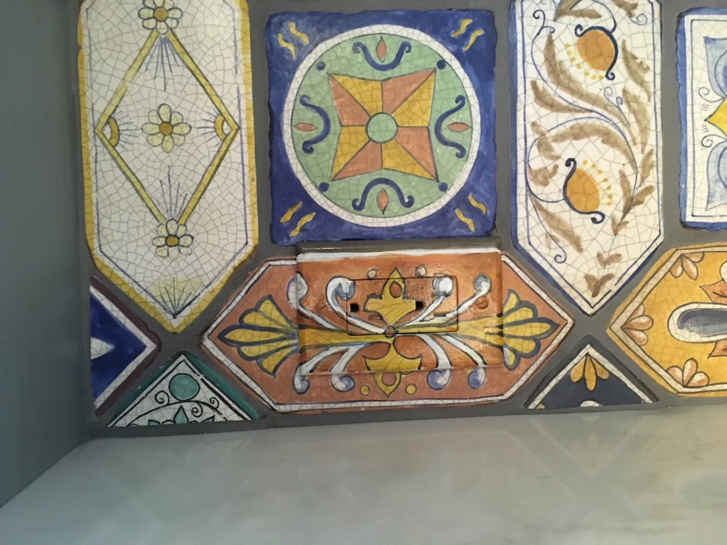 Closeup of Wall tiled with colorful ceramic tiles.
